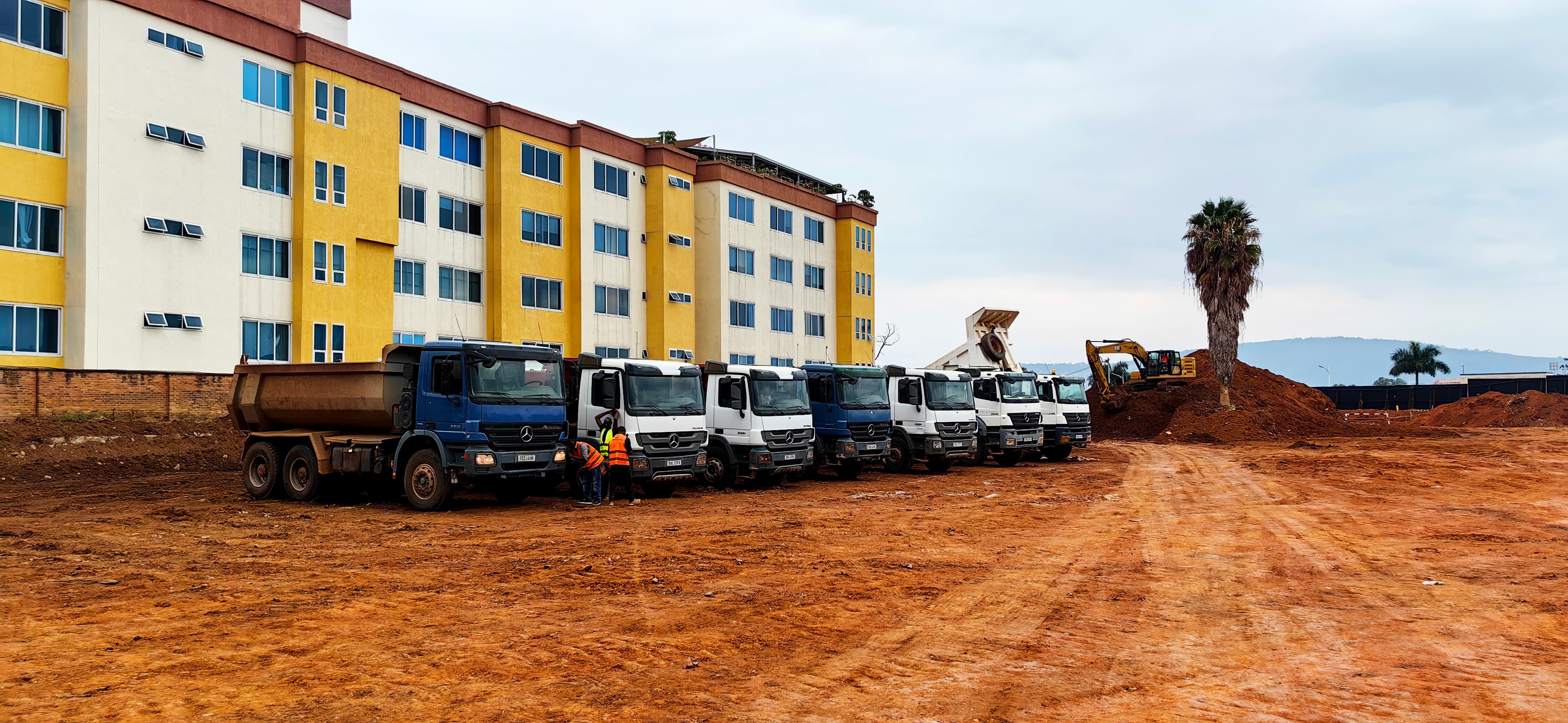KAYOS transport trucks staged at a project site
